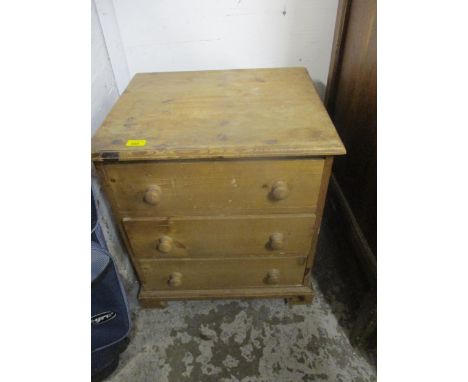 A pine three drawer bedside chest on bracket feet, 58cm x 52cm x 44cm 