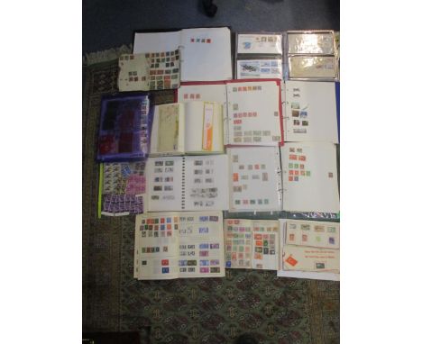 A collection of British and World stamps to include GB definitive stamps, first day covers, and others mounted in various alb