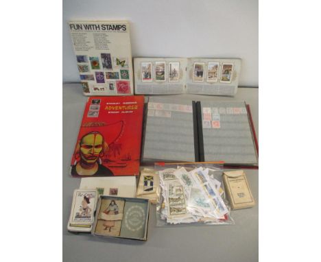 A selection of stamps in albums and loose, together with cigarette cards, some silk examples and playing cards 