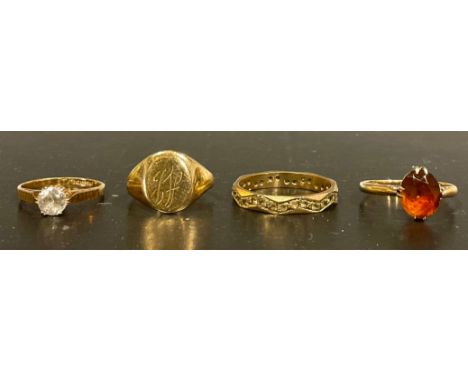 Four 9ct gold rings, to include a "9 375" stamped initialled signet ring, size H, a "9 375" stamped white paste stone solitai