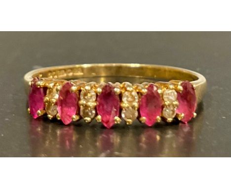 A 9ct gold ruby and diamond eternity ring, set with five approx. 4mm length x 2mm width deep pink marquise cut rubies and alt