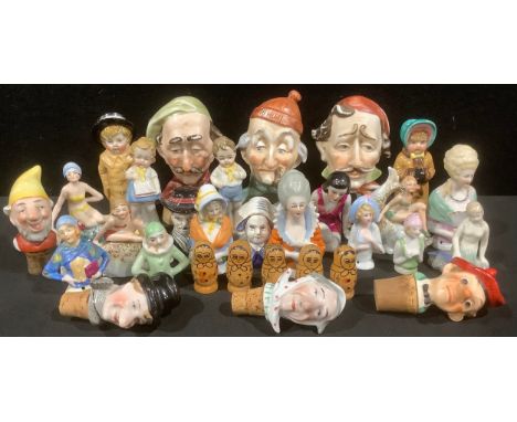 A late 19th/early 20th century pincushion or half doll, others similar; other continental porcelain figures, bottle toppers, 