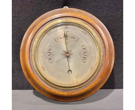 A Victorian oak cased aneroid barometer, silvered dial, Arabic numerals, 30cm diameter, c. 1890