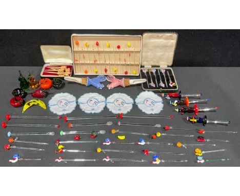 A set of continental glass cocktail sticks, the terminals as fruits, boxed; other glass cocktail sticks and stirrers; a set o
