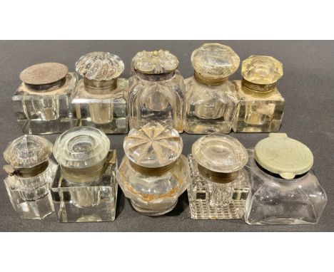 A Victorian pressed glass and brass mounted inkwell, the hinged cover cast with a flowerhead among scrolls, Gothic Revival bo