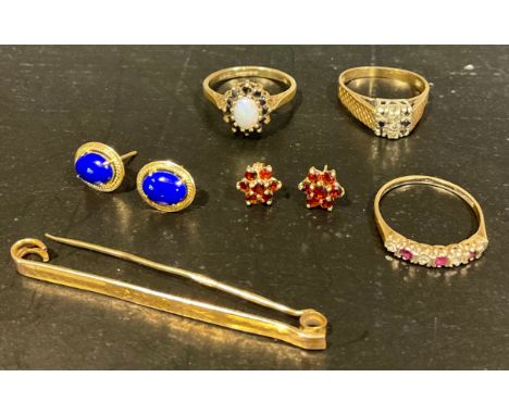 A selection of 9ct gold jewellery, to include a "9 375" stamped opal and sapphire ring, size P, a "9CT GOLD 375" stamped ruby