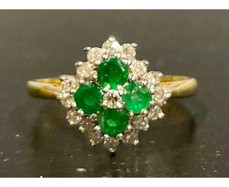A tested 18ct gold emerald and diamond cluster ring, set with four approx. 2.5mm diameter mid green round brilliant cut emera