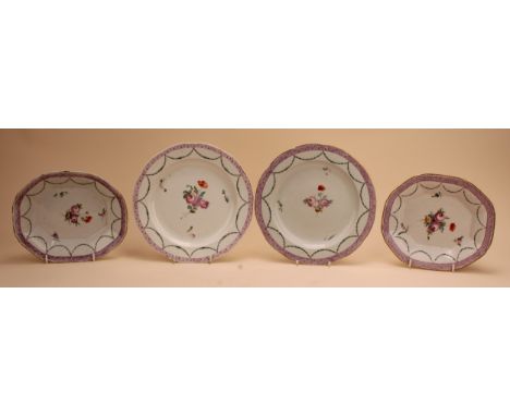 A pair of Chelsea Derby shaped circular plates painted with central floral bouquet under husk swags and a puce border, gilt d