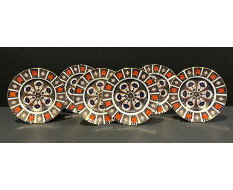 An associated set of six Royal Crown Derby Imari 1128 pattern dinner plates, 27cm diameters, various dates, printed marks