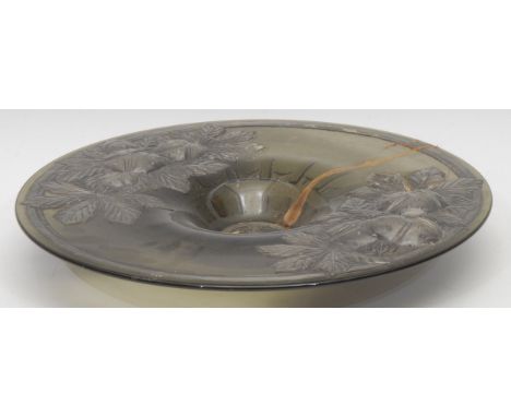 A French olive green pressed glass circular pedestal dish, the broad rim and field overlaid with pewter, boldly chased in hig