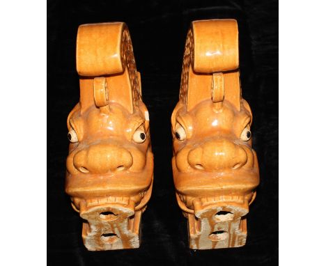Interior Decoration - a pair of monochrome glazed earthenware architectural fittings, each modelled as a Chinese dragon, 45cm