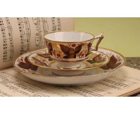 A Flight Barr and Barr teacup and saucer, painted with brown leaves and red flowers, picked out in gilt, impressed FBB mark, 