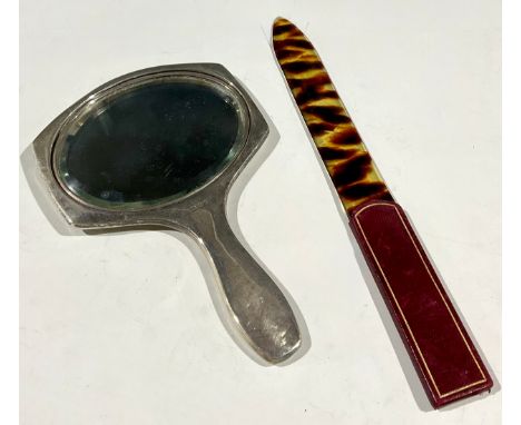 A hallmarked silver and tortoiseshell mirror; a tortoiseshell page turner 