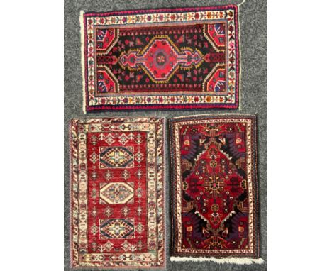 An Iranian wool mat or rug, 94cm x 62cm; another; another, Pakistan (3)