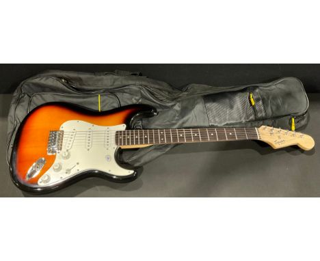 An electric Squier Bullet Strat guitar, by Fender, made in China, soft carry case