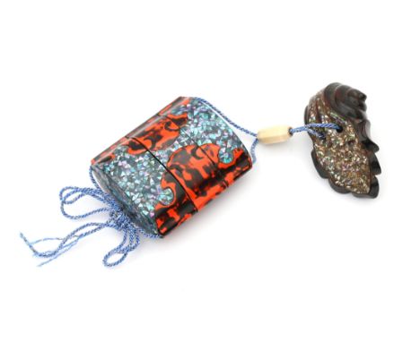  A Japanese lacquer two compartment inro decorated in neguro nori and mother of pearl. The shell shaped wooden netsuke also w