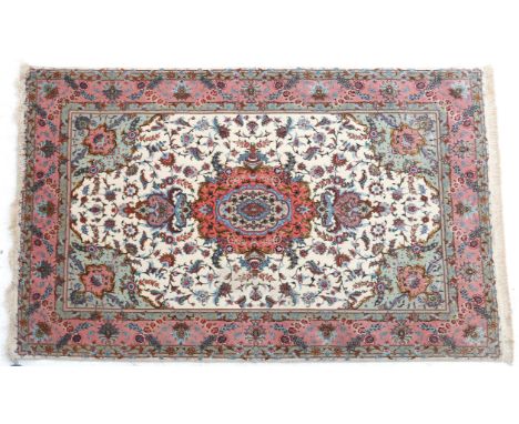  An Eastern tapestry with centrally a medaillon in the colours pink, green and yellow, Tabris. Afm: Lx160 Bx100 cm.