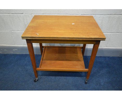 A MID 20TH CENTURY TEAK FOLD OVER CARD TABLE, lined with green baize, on square tapered legs, united by an undershelf, on cas