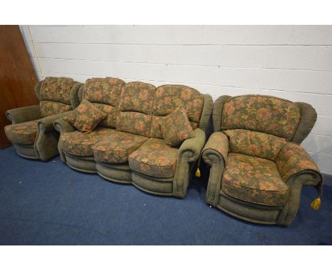 A GREEN AND FLORAL UPHOLSTERED THREE PIECE LOUNGE SUITE, comprising of a three seater sofa and two armchairs