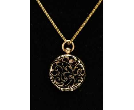 AN EARLY VICTORIAN MEMORIAL LOCKET NECKLACE, the locket of a circular form, decorated with black enamel and gold foliate deta