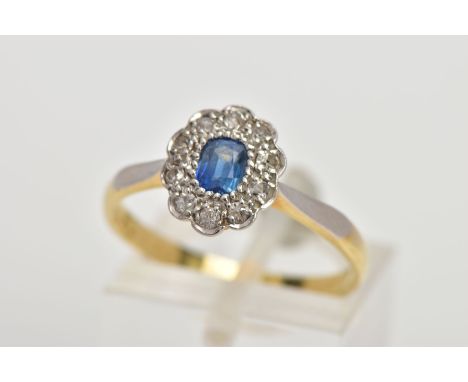 A YELLOW METAL SAPPHIRE AND DIAMOND CLUSTER RING, designed with a central oval cut blue sapphire, within a single cut diamond