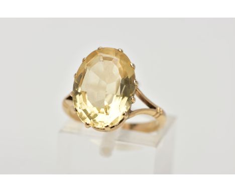 A YELLOW METAL CITRINE RING, designed with a twelve claw set, oval cut citrine, measuring approximately 14.8mm x 10.8mm, open