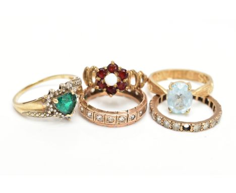 FIVE GEM SET RINGS, to include a garnet and opal cluster ring, an oval blue topaz ring, a heart design dress ring and two ete