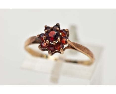 A 9CT GOLD GARNET CLUSTER RING, set with circular cut garnets, tapered shoulders, hallmarked 9ct gold Birmingham, ring size J