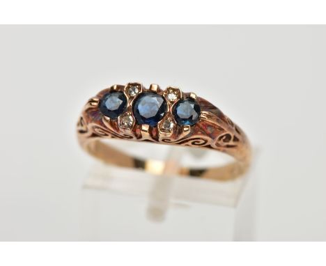 A 9CT GOLD SAPPHIRE AND DIAMOND RING, designed with three circular cut blue sapphires, interspaced with single cut diamonds, 