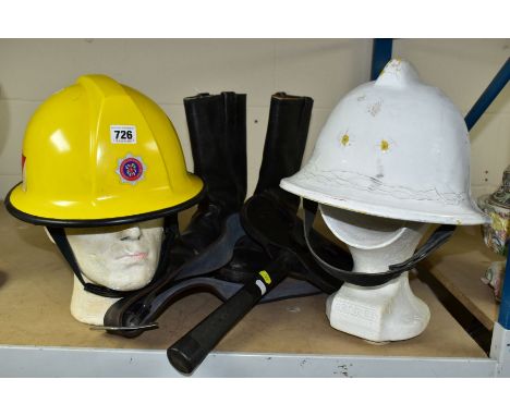 FIRE SERVICE INTEREST - TWO HELMETS, BOOTS AND AXE, the axe head in a sturdy leather pouch attached to a belt, textured grip,