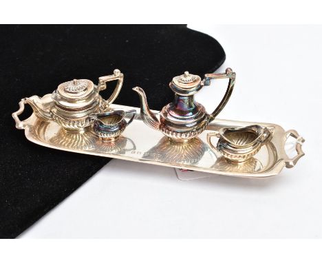 A MINIATURE FOUR PIECE TEA SERVICE SET WITH TRAY, comprising of a coffee pot and teapot both with covers, sugar bowl, and cre