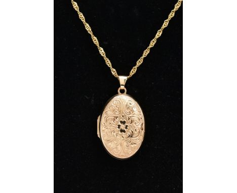 A 9CT GOLD LOCKET NECKLACE, the locket of an oval form, embossed floral design to the front, opens to reveal two vacant photo