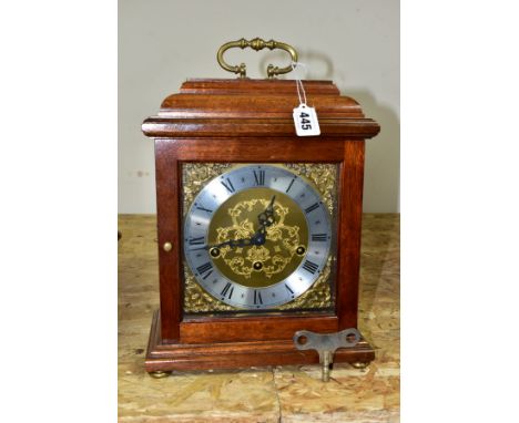 A REPRODUCTION MAHOGANY CASED FRANZ HERMLE BRACKET CLOCK, the caddy top fitted with a brass handle, gilt spandrels, the silve