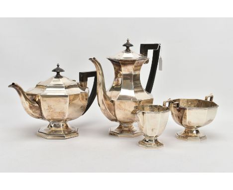 A GEORGE V FOUR PIECE SILVER TEA SERVICE SET, comprising of a teapot and a coffee jug each fitted with an ebonised handle and