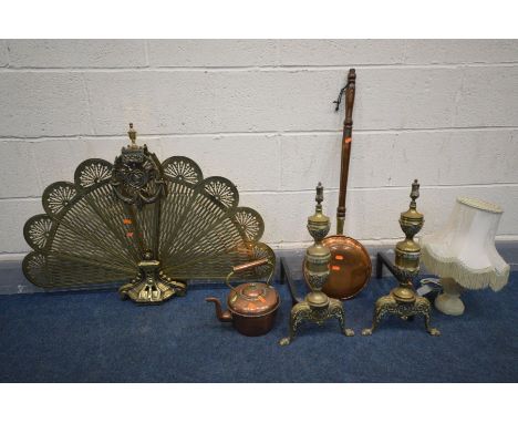 A PAIR OF BRASS ANDIRONS, along with a brass peacock fire screen, copper warming pan, kettle and an onyx table lamp (6)