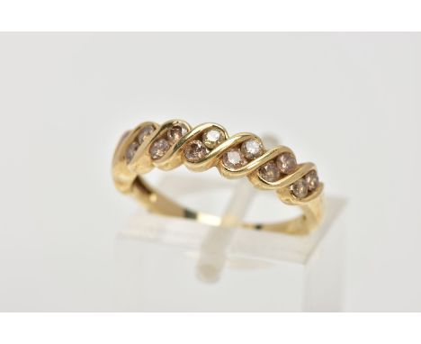 A 9CT GOLD DIAMOND HALF ETERNITY RING, set with two asymmetrical rows of round brilliant cut, tinted brown diamonds, total es