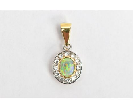 AN 18CT GOLD OPAL AND DIAMOND PENDANT, of an oval form, centring on a collect mounted oval cut opal, within a surround of rou