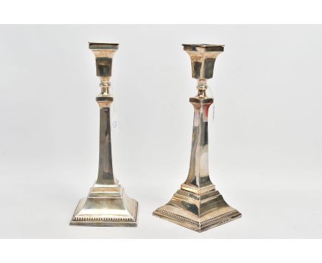 A PAIR OF SILVER CANDLESTICKS, each candlestick of a square design, tapered square stems and square stepped weighted bases wi