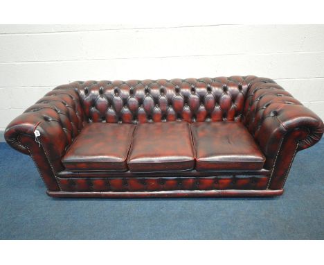 A LEATHER OXBLOOD CHESTERFIELD THREE SEATER SOFA, length 189cm x depth 83cm x height 70cm