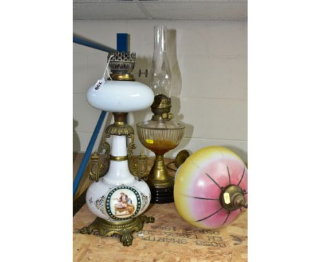 THREE LAMPS comprising an opaque white oil lamp with transfer and hand painted decoration, brass base and fittings to the bod