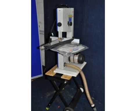 A CHARNWOOD W715 BANDSAW with 10in mouth 1712mm blade length, push stick, parallel guide and mitre guide mounted on a workmat