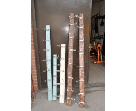 A TOTAL OF 32 MID CENTURY WIRE COAT HOOKS MOUNTED TO FIVE PINE PLANKS