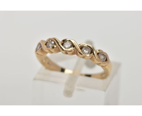 A 9CT GOLD DIAMOND HALF ETERNITY RING, designed with a row of five round brilliant cut diamonds, each within a shared cross o