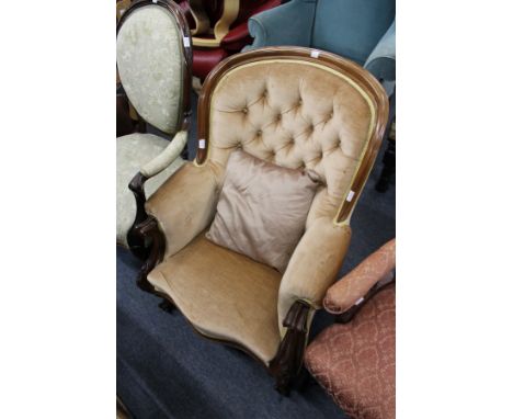 A good Victorian mahogany framed button back armchair with carved decoration.