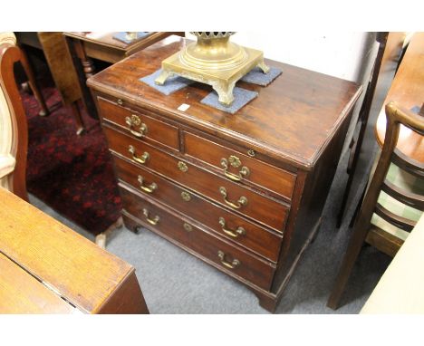A George III mahogany bachelor's chest with brushing slide, two short and three graduated long drawers on bracket feet.