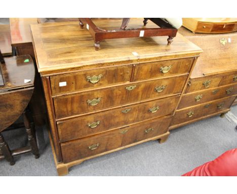 An 18th century walnut chest of two short and three graduated long drawers (top stripped and re-polished) on later bracket fe