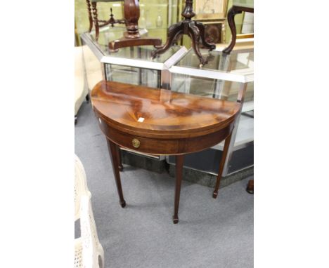 A mahogany D-shaped foldover card table with a single drawer on tapering square legs.