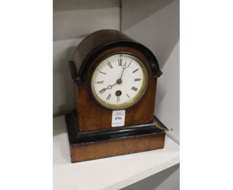 A mahogany mantle clock.
