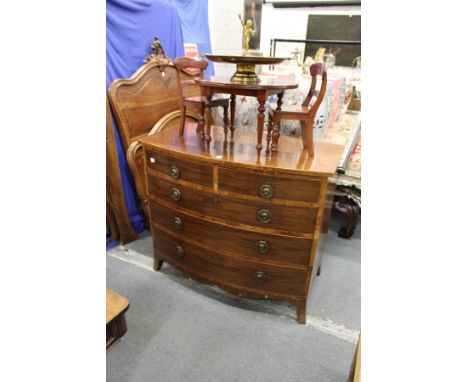 A George III mahogany bowfront chest of two short and three graduated long drawers on splay bracket feet.