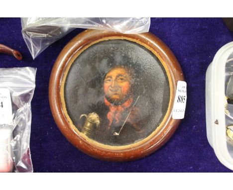 A small circular portrait of a man with a pipe and flagon of foaming ale (lid of a papier mache box).